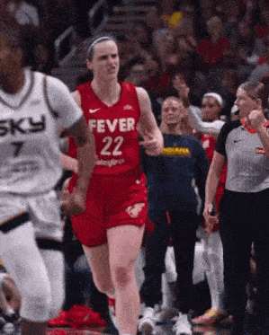 a female basketball player in a red fever 22 jersey