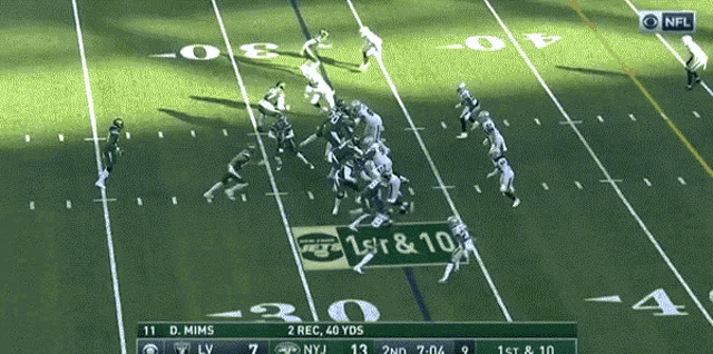 a football game is being played on a field with a sign that says 1st & 10