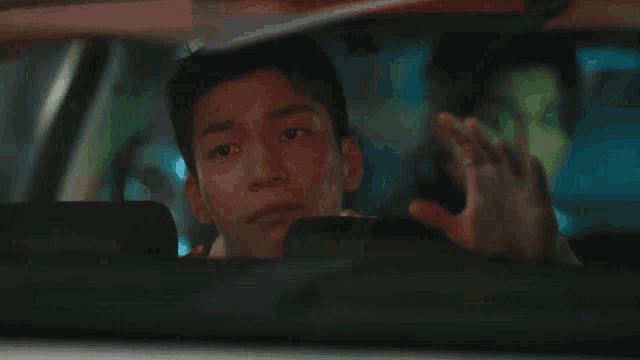 a man in a car with the word goodness written on the screen