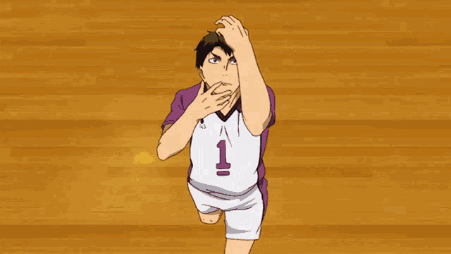 a man is holding a volleyball in his hand on a basketball court .