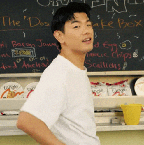 a man stands in front of a blackboard that says the " dos "