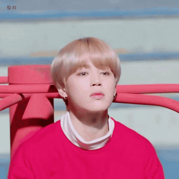 a close up of a person wearing a red shirt with a white turtleneck