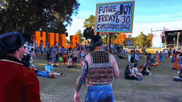 a man is holding a sign that says future joy friday 6:30 campground stage