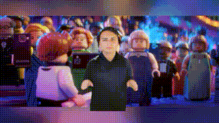 a man is standing in front of a crowd of lego figures .