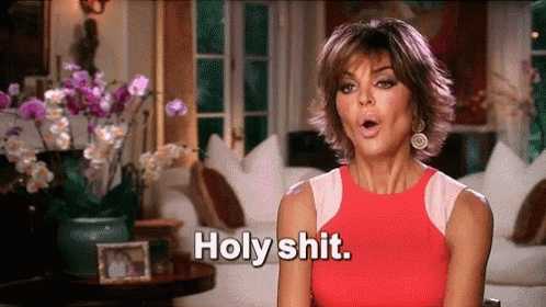 a woman in a red top is saying holy shit .