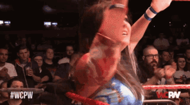 a woman in a boxing ring with #wcpw on the bottom right