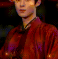 a man in a red kimono is standing in front of a fence