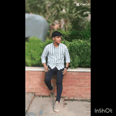 a young man leaning against a brick wall with inshot written on the bottom