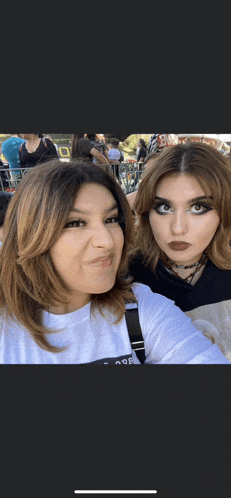 two women posing for a picture with one wearing a white t-shirt that says nof