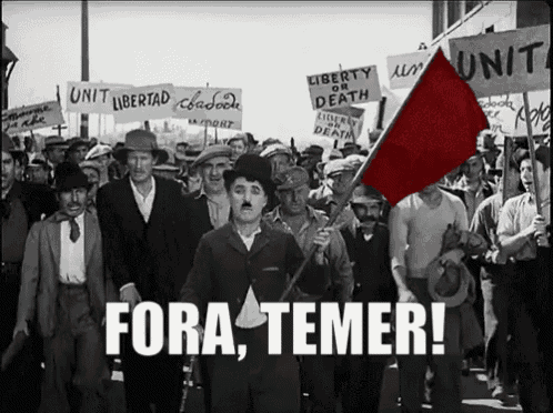 a group of people marching down a street with a sign that says unit