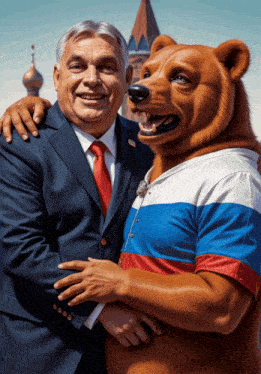 a man in a suit and tie is posing with a bear wearing a russian shirt