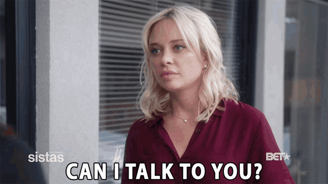 a woman says " can i talk to you " in front of a window