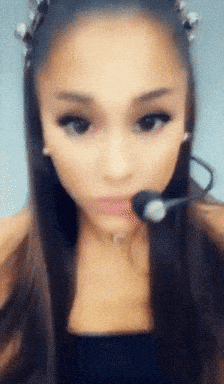 a close up of a woman wearing a microphone in her mouth