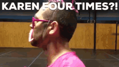 a man with pink paint on his face is wearing glasses .