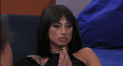 a woman wearing a choker and a black top is smiling
