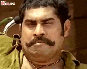 a man with a mustache is making a face .