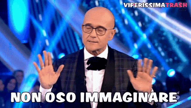 a bald man in a tuxedo and bow tie says " non oso immaginare "
