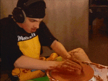 a man wearing headphones and a yellow apron with the word animal on it