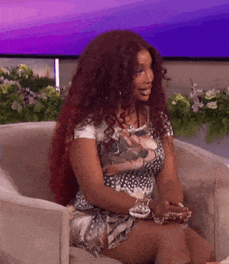 a woman is sitting in a chair with her legs crossed