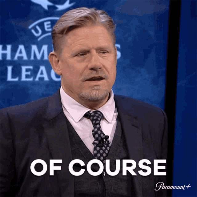 a man in a suit and tie says " of course " in front of a paramount logo