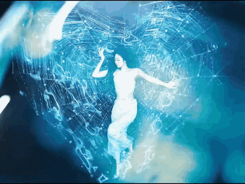 a woman in a white dress is surrounded by a blue spider web