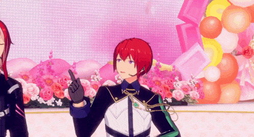 a man with red hair is standing in front of flowers and balloons