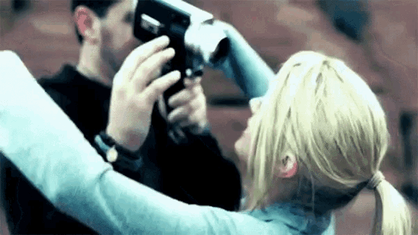 a man is taking a picture of a woman with a camera ..