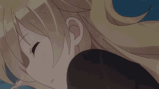 a close up of a blonde anime girl sleeping