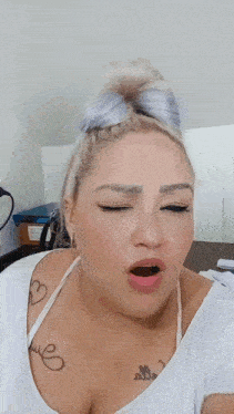 a woman with a tattoo on her chest that says ' elle '