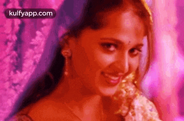 a close up of a woman 's face with a purple background .