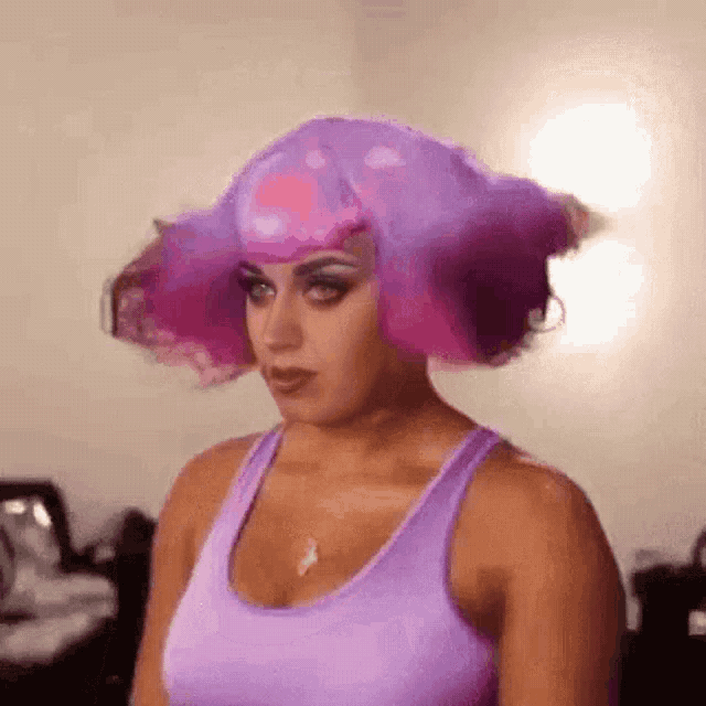 a woman wearing a purple wig and a purple tank top