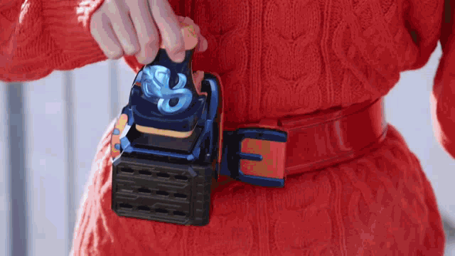 a person wearing a red sweater and a red belt with the letter e on it .