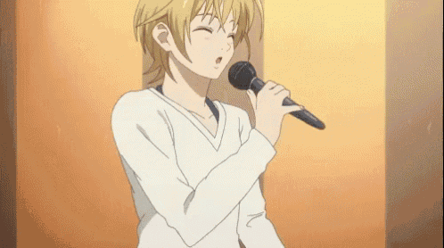 a girl is singing into a microphone in a room .