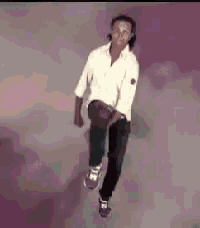 a man in a white shirt and black pants is dancing in the air .