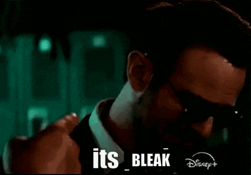 a man in a suit and tie is wearing sunglasses and says its bleak .