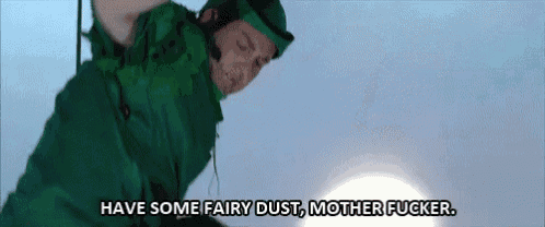 a man in a green suit is flying through the air and says `` have some fairy dust , mother fucker '' .