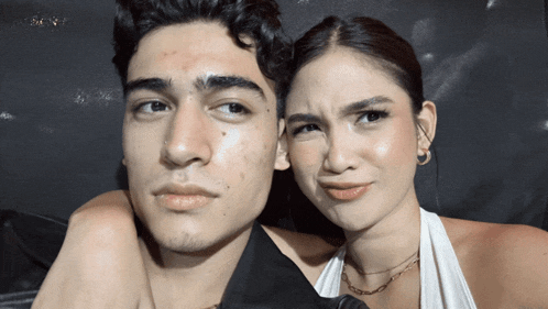 a man and a woman are posing for a picture together