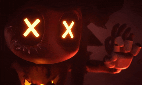 a close up of a pumpkin with glowing eyes and x 's on it 's face .