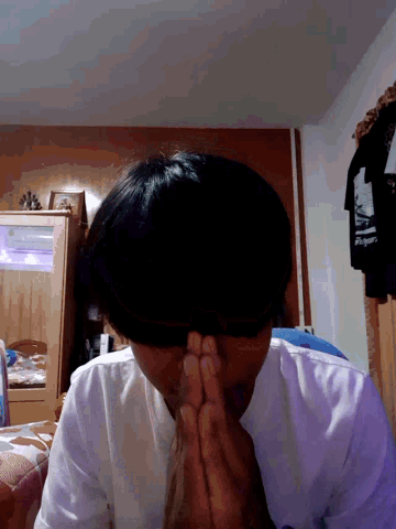 a person laying on their back with their hands on their face and a bottle of shampoo in the background