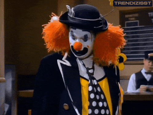 a man dressed as a clown with the word trendizisst on the bottom