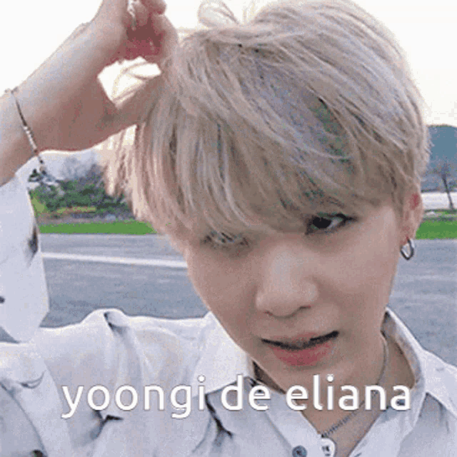 a close up of a person 's face with the words yoongi de eliana written below it