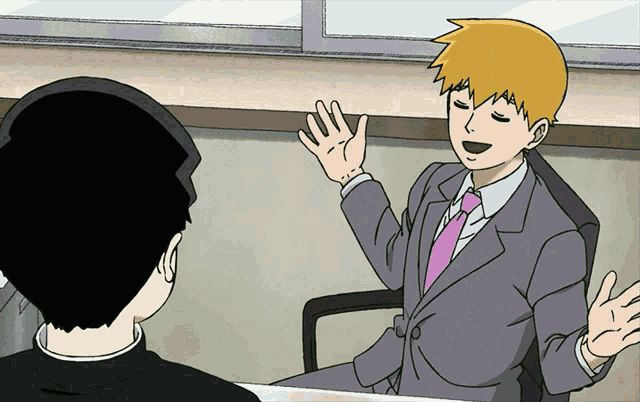 a man in a suit and tie is sitting in a chair talking to another man