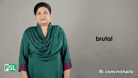 a woman in a green shirt is making a sign that says brutal