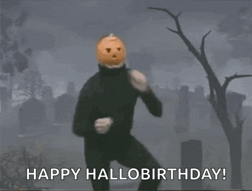a man with a pumpkin on his head is dancing in a cemetery and saying happy hallo birthday .