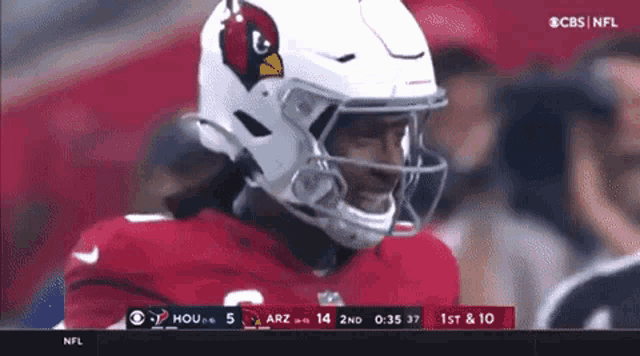 a football player wearing a white helmet with a cardinals bird on it