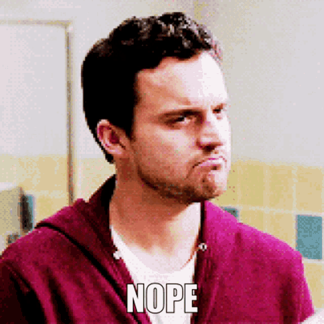 a man wearing a purple sweater has the word nope on his face
