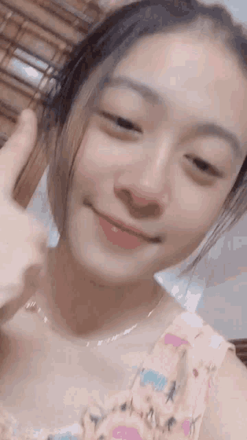 a close up of a girl giving a thumbs up sign