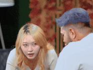 a man and a woman are sitting next to each other in a room .