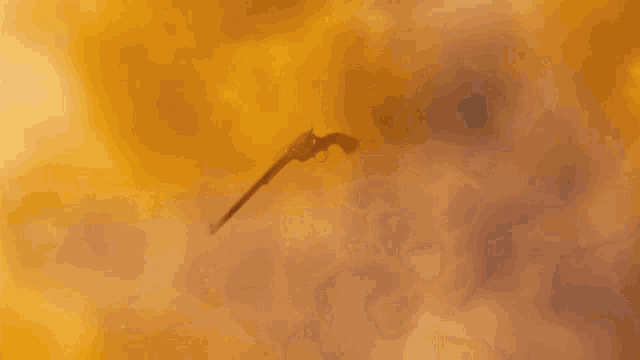 a close up of a gun with smoke coming out of the barrel