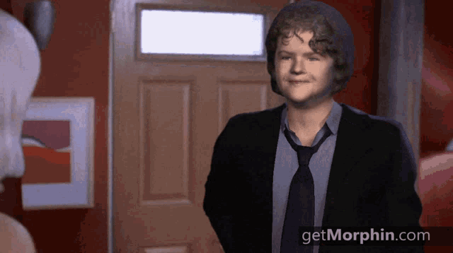 a picture of a man in a suit and tie with the website getmorphin.com displayed
